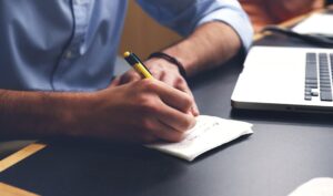 man writing down information to sell an industrial generator